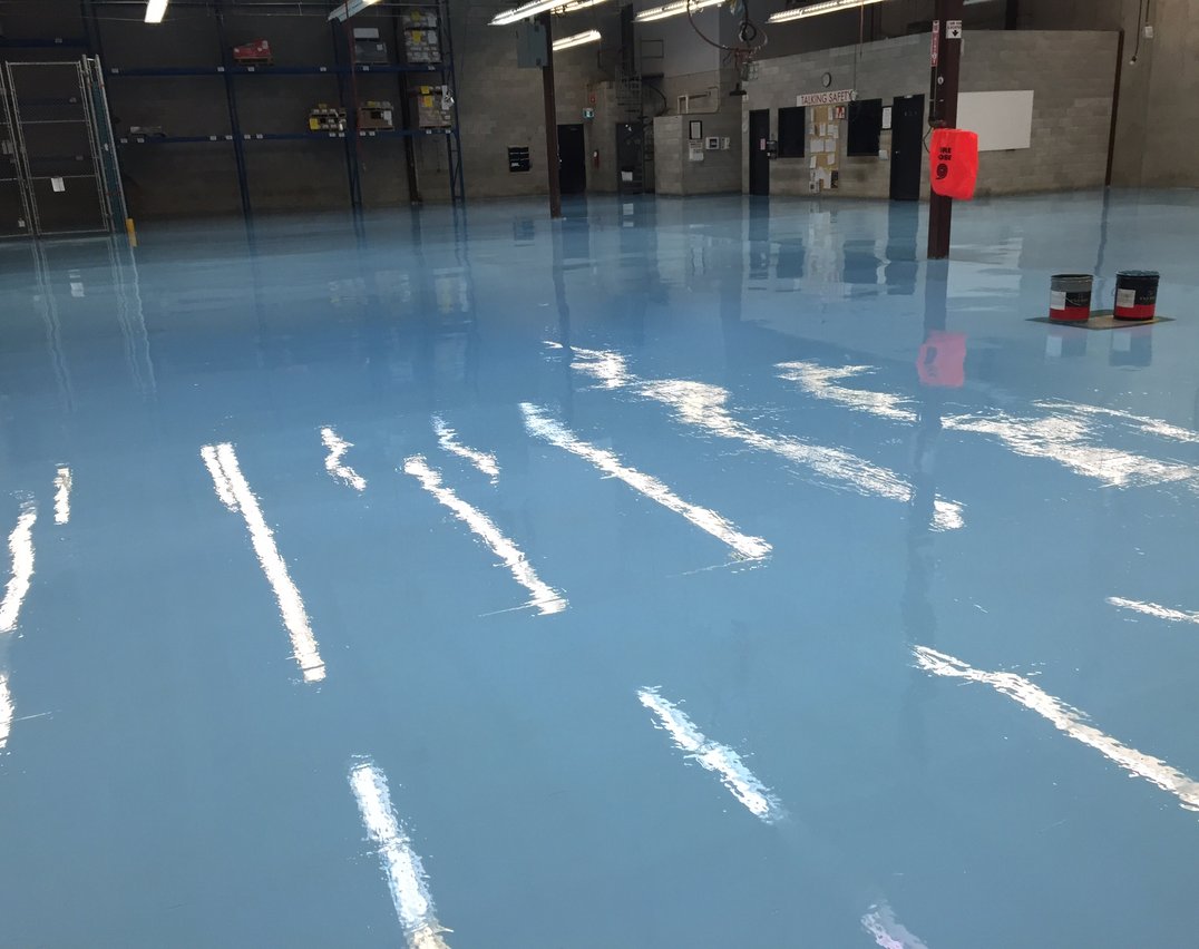 Blue epoxy flooring installed in a Mississauga industrial warehouse