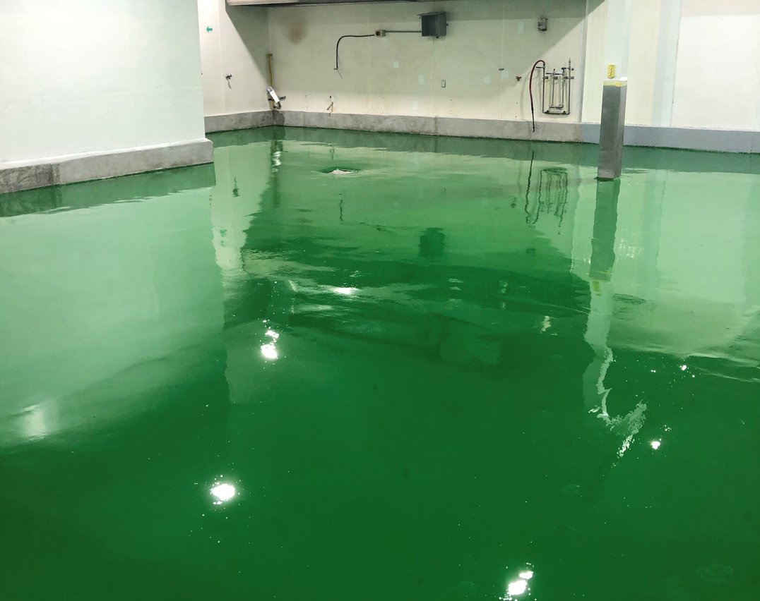 Floor-level view of green epoxy flooring in a Toronto food and beverage facility