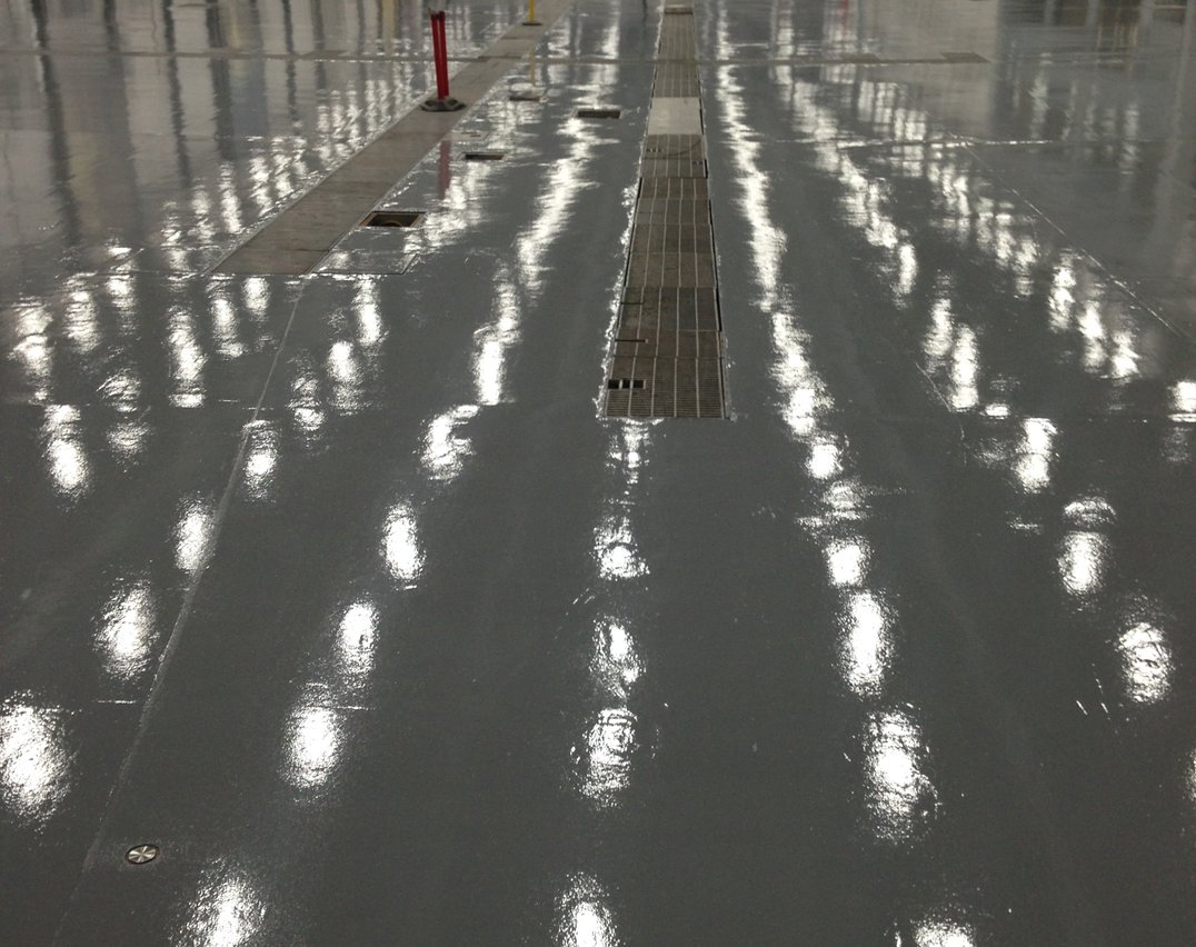 Dark gray epoxy floor in a large Vaughan industrial warehouse